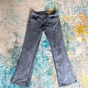 Black acid-washed jeans with flare legs.
